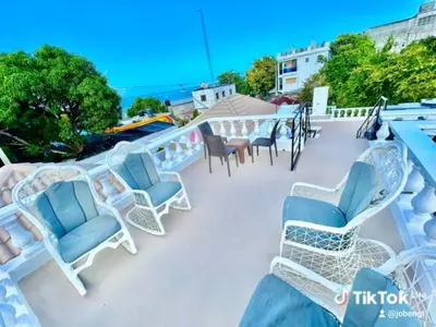 a group of chairs and tables on a balcony at Room 4 in Río San Juan