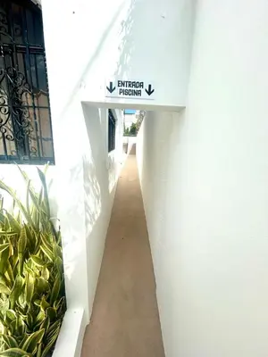 a hallway with a sign on the side of a building at Room 4 in Río San Juan