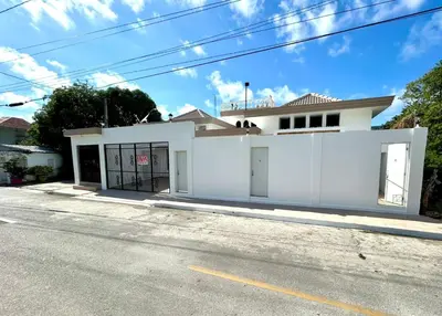 a white house on the side of a street at Room 4 in Río San Juan