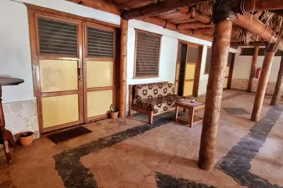a room with a couch and a table and windows at Coco's Apartment near La Playita beach in Las Galeras