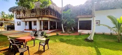 a house with a table and chairs in a yard at Coco's Apartment near La Playita beach in Las Galeras