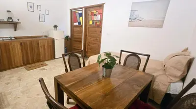 a living room with a wooden table and chairs at Coco's Apartment near La Playita beach in Las Galeras