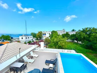 a view of a swimming pool and chairs on a roof at Room 3 in Río San Juan