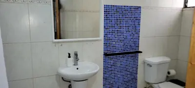 a bathroom with a sink and a toilet and a mirror at Room 3 in Río San Juan