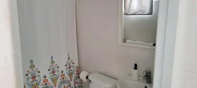 a bathroom with a toilet and a sink and a mirror at Room 5 in Río San Juan