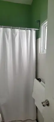 a bathroom with a shower curtain and a sink at Room 7 in Río San Juan