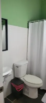 a bathroom with a white toilet and a sink at Room 7 in Río San Juan