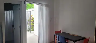 a room with a table and a sliding glass door at Room 7 in Río San Juan