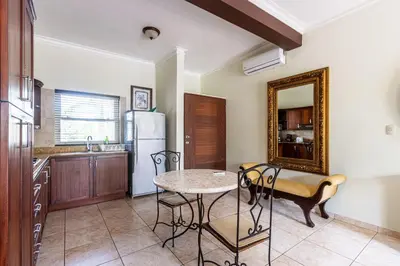 a kitchen with a table and chairs in a room at Garden Studio, Ocean Dream in Cabarete