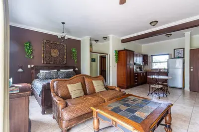 a living room with a couch and a table at Garden Studio, Ocean Dream in Cabarete