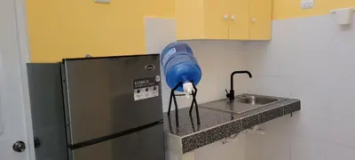 a kitchen with a blue blow dryer attached to a sink at Room 6 in Río San Juan