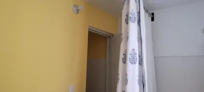 a bathroom with a shower curtain and a door at Room 6 in Río San Juan