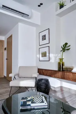 a living room with a couch and a glass table at Regatta Living Suites by Yellowkey in Santo Domingo