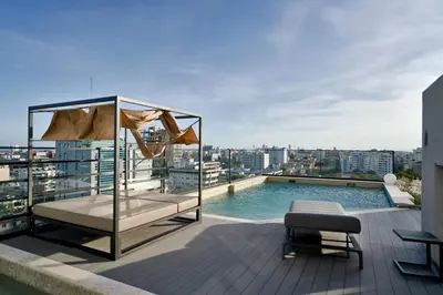 a pool on the roof of a building at Regatta Living Suites by Yellowkey in Santo Domingo