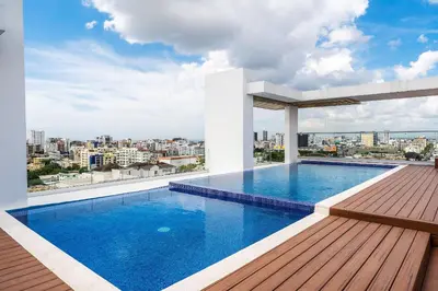 a swimming pool on the roof of a building at Splendid-KingBed-3BR-Pool-AC-Modern-WiFi-Yellowkey in Santo Domingo