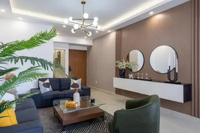 a living room with a blue couch and two mirrors at Splendid-KingBed-3BR-Pool-AC-Modern-WiFi-Yellowkey in Santo Domingo