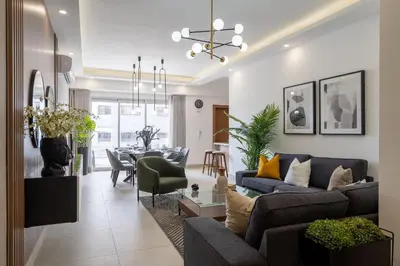 a living room with a couch and a dining room at Splendid-KingBed-3BR-Pool-AC-Modern-WiFi-Yellowkey in Santo Domingo