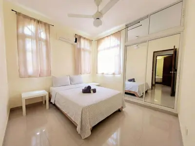 a bedroom with a bed and a mirror at 2-Bedroom Beach Apartment with Pool Costambar in San Felipe de Puerto Plata