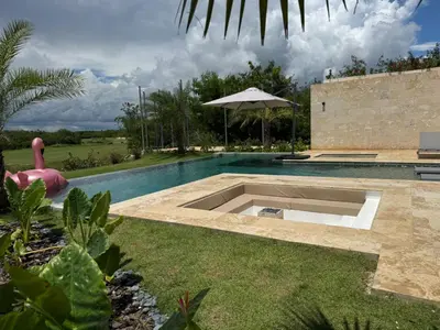 a swimming pool in the middle of a yard at Golf 218 Playa Nueva Romana in San Pedro de Macorís