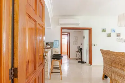 a room with a door and a kitchen with a counter at Spacious 2 Bedroom Condo with Pool close to Beach in Punta Cana