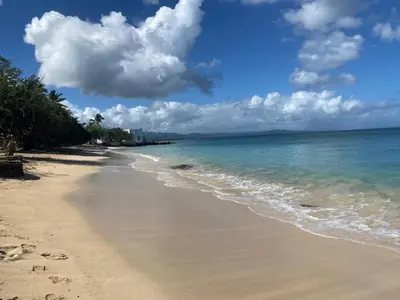 a beach with the ocean and clouds in the sky at Room 1 in Río San Juan