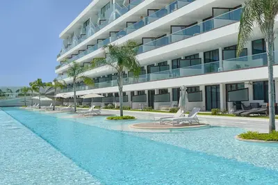 a swimming pool in front of a building at Cana Rock Star in Punta Cana