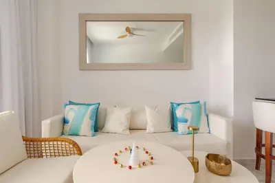 a living room with a table with a cake on it at Cana Rock Star in Punta Cana