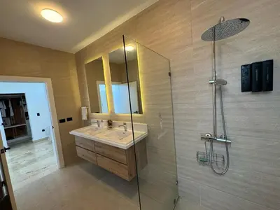 a bathroom with a sink and a glass shower at Golf 218 Nueva Romana Beach in San Pedro de Macorís