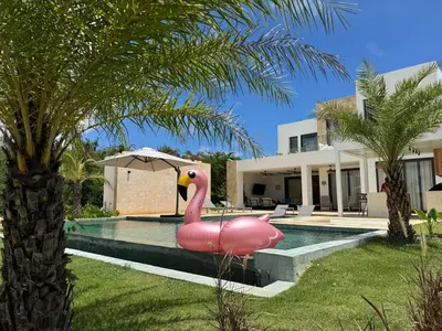 a pink inflatable flamingo in front of a house at Golf 218 Nueva Romana Beach in San Pedro de Macorís