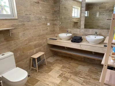 a bathroom with two sinks and a toilet at Punta Popy 3BR Duplex with Pool, Walk to Beach in Las Terrenas
