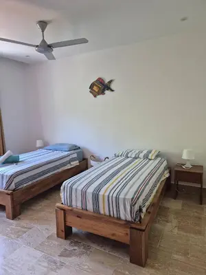 a bedroom with two beds and a ceiling fan at Punta Popy 3BR Duplex with Pool, Walk to Beach in Las Terrenas