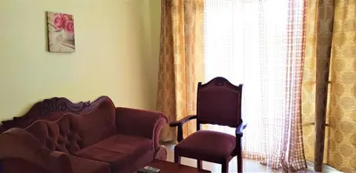 a living room with a couch and a chair and a window at Beach Apartment with Pool - Costambar in Las Flores