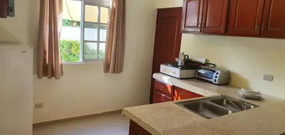a kitchen with a sink and a microwave at Beach Apartment with Pool - Costambar in Las Flores