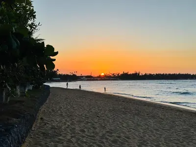 a beach with the sun setting in the distance at Romantic Beachfront Retreat In Las Terrenas - Everything You Could Want - 2 Rooms in Las Terrenas