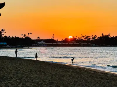 a group of people walking on the beach at sunset at Romantic Beachfront Retreat In Las Terrenas - Everything You Could Want - 2 Rooms in Las Terrenas