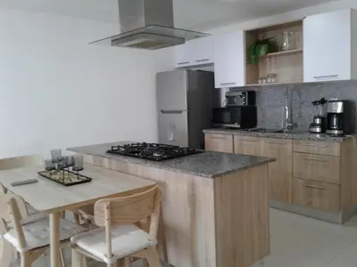 a kitchen with a stove and a table with chairs at Apartamento en Boca Chica T1 610 in Boca Chica