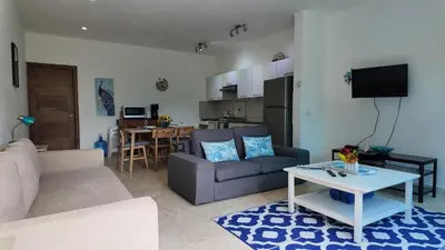 a living room with a couch and a table at La Fenice Beachfront Apartment in Las Terrenas