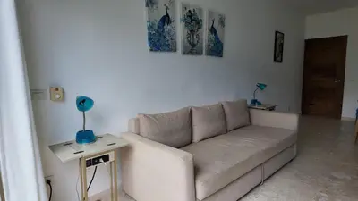 a living room with a couch and a table at La Fenice Beachfront Apartment in Las Terrenas