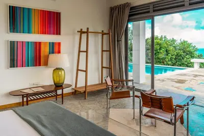 a bedroom with a bed and a view of a pool at Villa Mustique - Perfect tropical paradise in El Limón