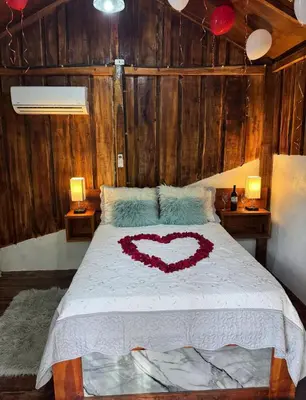 a bedroom with a bed with a heart drawn on it at enjoy the nature of the countryside in Bonao
