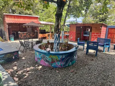a tree in a pot with a fountain in a yard at enjoy the nature of the countryside in Bonao