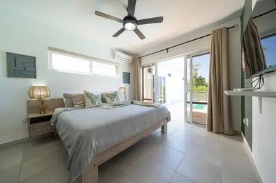 a bedroom with a bed and a ceiling fan at Ocean View, Style, Freedom in Sosúa