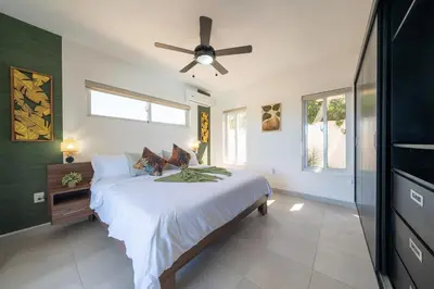a bedroom with a bed with a ceiling fan at Ocean View, Style, Freedom in Sosúa