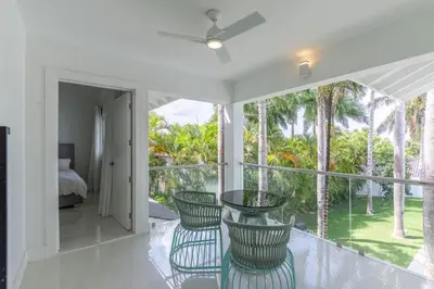 a room with a balcony with chairs and a bed at Casa Deco in La Romana