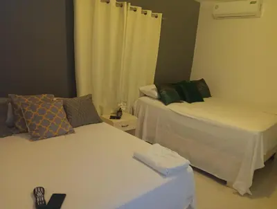 a room with two beds in a room at Hospedaje Las Flores Pedernales in Pedernales