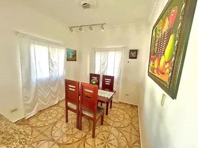 a dining room with a table and chairs in a room at Villa Rosa 3 Habitaciones Balcones Aire Acondicionado Espacio Ideal Para Tu Familia O Grupo in Río San Juan
