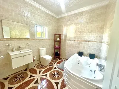 a bathroom with a tub and a toilet and a sink at Villa Rosa 3 Habitaciones Balcones Aire Acondicionado Espacio Ideal Para Tu Familia O Grupo in Río San Juan