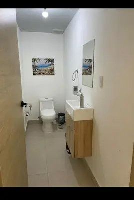 a white bathroom with a toilet and a sink at Residencial JT1 Avenida España in La Viva