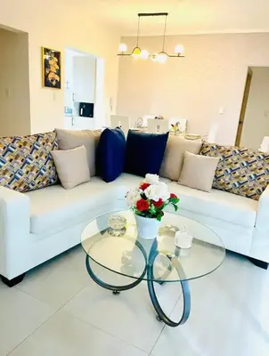 a living room with a white couch and a glass table at Residencial JT1 Avenida España in La Viva