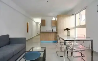 a living room with a couch and a table at Encanto en gazcue - Cerca del Malecón y la Zona Colonial in Santo Domingo